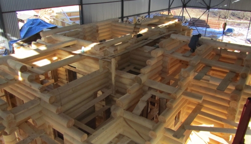 Construction of a wooden house under cover