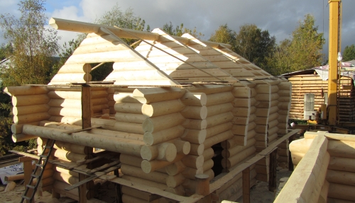 Building a log house on the construction site